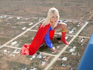 breasts giantess collage mega blonde cleavage boots kneeling supergirl cape looking_at_viewer
