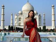 giantess black_hair smiling sitting forced_perspective crowds india indian taj_mahal