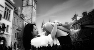 collage city monochrome black_hair barefoot asian legs shorts people between_buildings white_top mrscaryface on_her_back