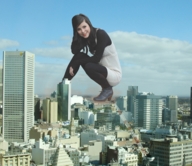 giantess collage city black_hair clothed smiling kneeling clouds sky looking_at_viewer heeled_boots