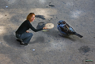 collage clothed jeans red_hair kneeling shrunken_woman bird black_top looking_at_viewer