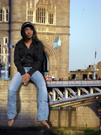 giantess collage black_hair barefoot jeans sitting pigtails sky jacket tower_bridge cap