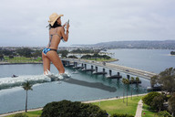 giantess collage mega butt swimsuit bridge water wonderslug falling dangle captured hat rihanna hanging_on behind_view holding_boat