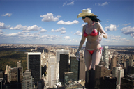 bikini giantess collage city swimsuit unknown_artist looking_down sunglasses between_buildings ear_ring rooftop_view