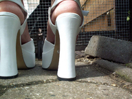 collage high_heels scared shrunken_man found outdoors business_man behind_view