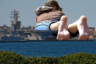giantess collage beach barefoot water soles lying_down aircraft_carrier pier behind_view loading_docks