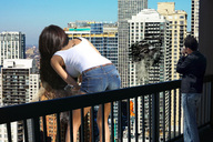 giantess collage city destruction helicopter brunette wonderslug shorts bending_over skyscrapers balcony damage leaning_forward behind_view viewer