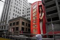 giantess collage city black_hair long_hair buildings jeans jr skyscraper red_lips phone_booth necklace leopard_top beige