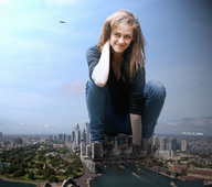 city mega destruction clothed jeans brunette smiling squatting airplane sneakers skyscrapers looking_up crouching crowds kristen_stewart ps3_has_no_games