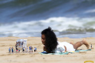 collage clothed beach barefoot lying_down sand dark_skin lowerrider looking_at_tiny guard_shack