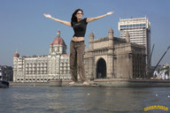 giantess collage black_hair clothed barefoot buildings glasses smiling belly boats waterfront lowerrider