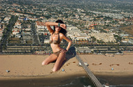 giantess collage black_hair swimsuit beach buildings helicopter wonderslug kneeling foot_print sand aerial_view looking_at_viewer beads resort pier beach_goers jenna_pietersen