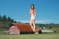 breasts giantess collage mega brunette wonderslug legs belly shorts farm barn sky trees fence looking_at_viewer farmers_daughter bare_legs