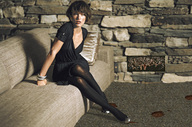 crush collage micro shoes blood brunette stockings dress short_hair shrunken_people indoors living_room looking_at_viewer sofa milla_jovovich giantesscity
