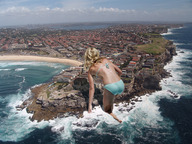 collage mega blonde swimsuit beach ocean buildings wet wonderslug waves clouds sky rocks distant_city rocky_shore downward_angle