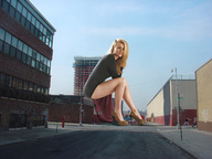 giantess collage blonde high_heels buildings wonderslug sitting legs streets sky yvonne_strahovski looking_at_tiny