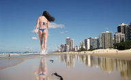 giantess collage butt swimsuit beach buildings brunette wonderslug walking foot_print sand athletic sky behind_view michelle_lewin