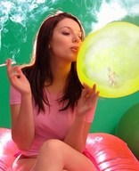 nude brunette shrunken_men sitting shrunken_man captured legs_crossed pink_shirt smoking_giantess