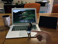 black_hair long_hair clothed barefoot cleavage finger surprised hand shorts shrunken_woman desk manicure looking_at_viewer computer poking digital_render coffee_mug macbook_air