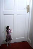 collage clothed brunette dress shrunken_woman looking_up necklace belt door