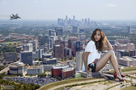 collage city mega high_heels brunette sitting jets vehicles sitting_on_building lowerrider