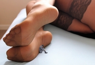 collage clothed barefoot soles bed sitting nylons shrunken_man indoors curled_up leaning_against_foot