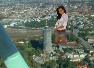 breasts giantess collage city mega long_hair skirt brunette kneeling outdoors belt gtsvideos1
