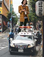 gentle giantess collage city black_hair clothed buildings smiling asian pants coffee onlookers jacket police_car airraid