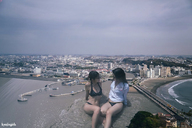 bikini gentle giantess collage city black_hair long_hair bridge ocean buildings wet glasses asian sitting waves sunglasses giantesses women shirt kyojingirls
