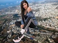 giantess collage giga city black_hair long_hair clothed shoes sitting outdoors