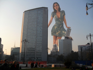 breasts giantess collage city mega long_hair destruction clothed cleavage buildings brunette dress walking outdoors
