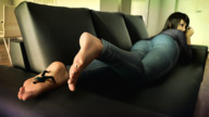 gentle feet black_hair long_hair clothed toes barefoot soles lying_down shrunken_man resting indoors nail_polish looking_back on_foot sofa relaxing bangs digital_render mobiusone