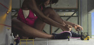 drawing giantess color clothed buildings brunette sitting vehicles dark_skin indoors leotard hangar bare_legs tying_shoe matthew_huntley