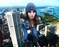 collage city color clothed cleavage buildings green_eyes jeans smiling boots unknown_artist river clouds outdoors sky looking_at_viewer source_needed beanie cleavage_window
