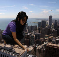 giantess black_hair clothed jeans smiling squatting hand looking_down skyscraper pink_nails nikemd aircraft