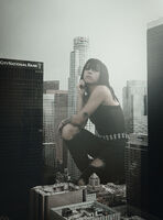 giantess city monochrome clothed jeans unknown_artist kneeling skyscraper tattoo looking_at_viewer belt bangs