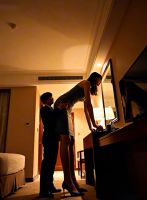 giantess shrunken_man butt_worship tall_tales gentle clothed asian mini_giantess bending_over standing size_comparison desk hotel_room mini_skirt ai_art