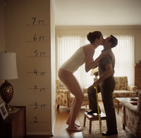 gentle butt barefoot brunette kissing amazon bending_over standing size_comparison living_room top measuring stool measuring_tape ai_art shrunken_man