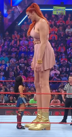 giantess black_hair long_hair clothed giganta red_hair standing size_comparison costume wonder_woman mini_skirt audience wrestling_ring dc_comics ai_art shrunken_woman shrunken_man giantesshug