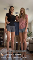 breasts mini_giantess giantesses gentle blonde long_hair clothed barefoot brunette amazon shorts women hugging standing size_comparison living_room looking_at_viewer tshirt ai_art Ai_art