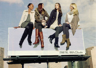 giantess city blonde brunette boots sitting advertisement giantesses dark_skin jacket billboard