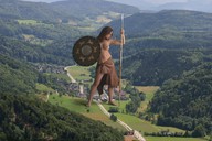 breasts giantess collage landscape mega barefoot skirt brunette topless weapon village forest outdoors ripped_clothing artdent spear shield makeshift_clothing