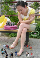 gentle collage feet asian sandals looking_down tinies pedicured handbag bench